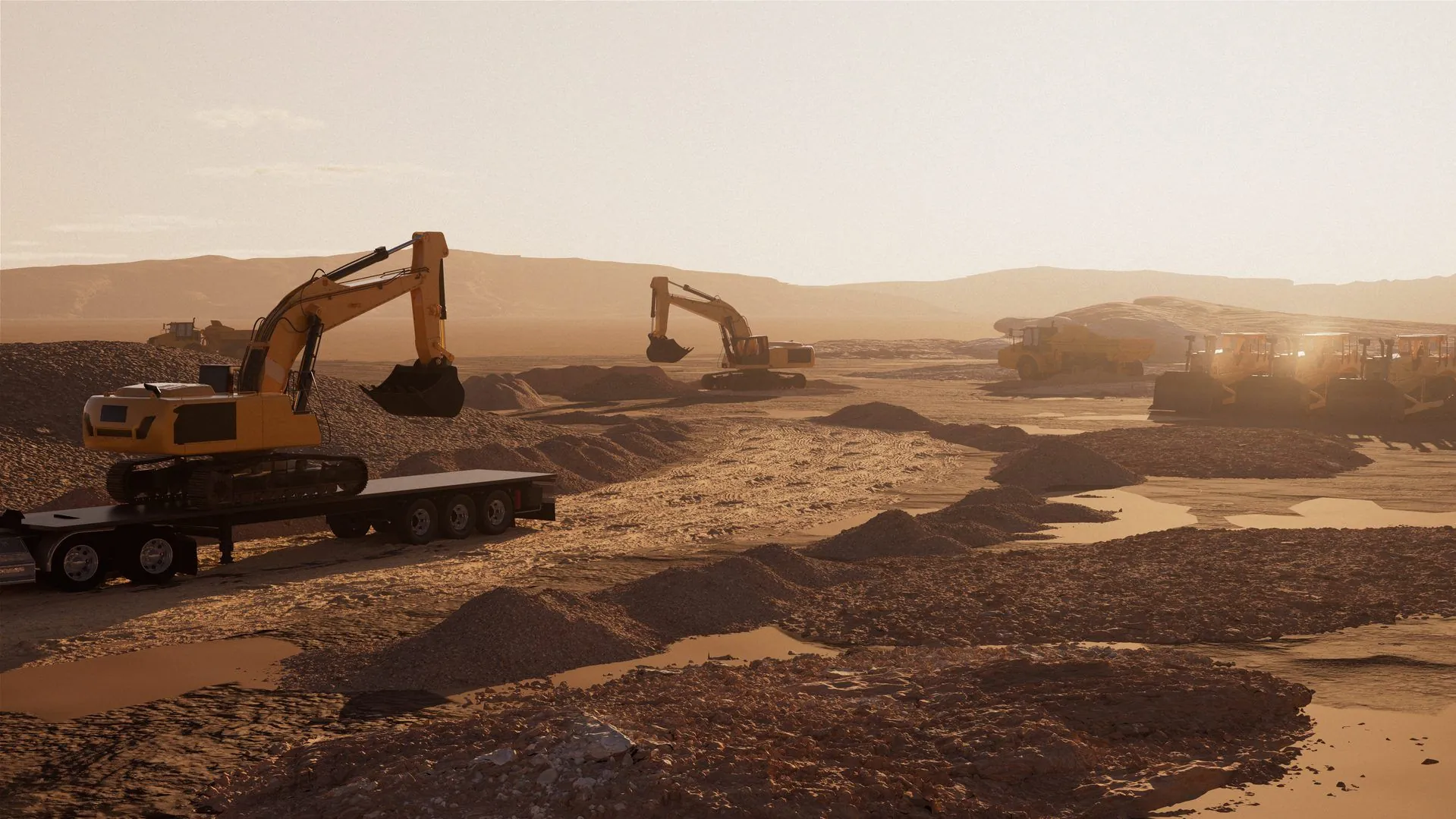 Excavators and a lowboy trailer staged at a large job site